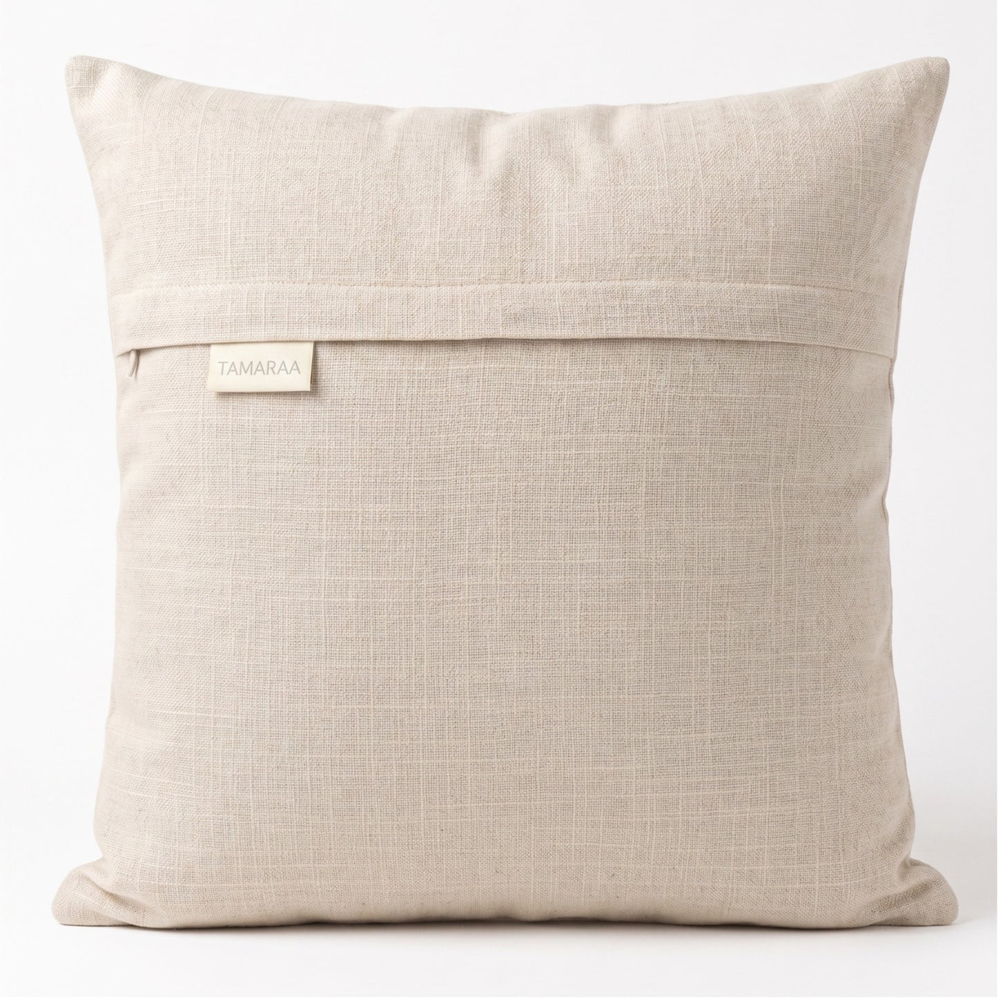 Beige pillow with a visible brand label on a white background
