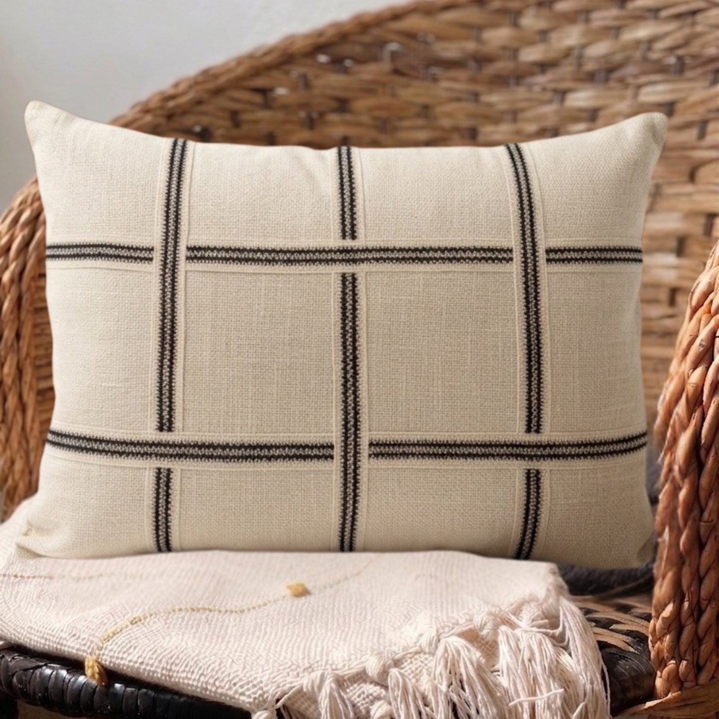 Neutral designer throw pillow with structured woven design