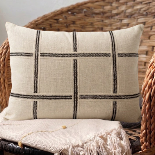 Neutral designer throw pillow with structured woven design